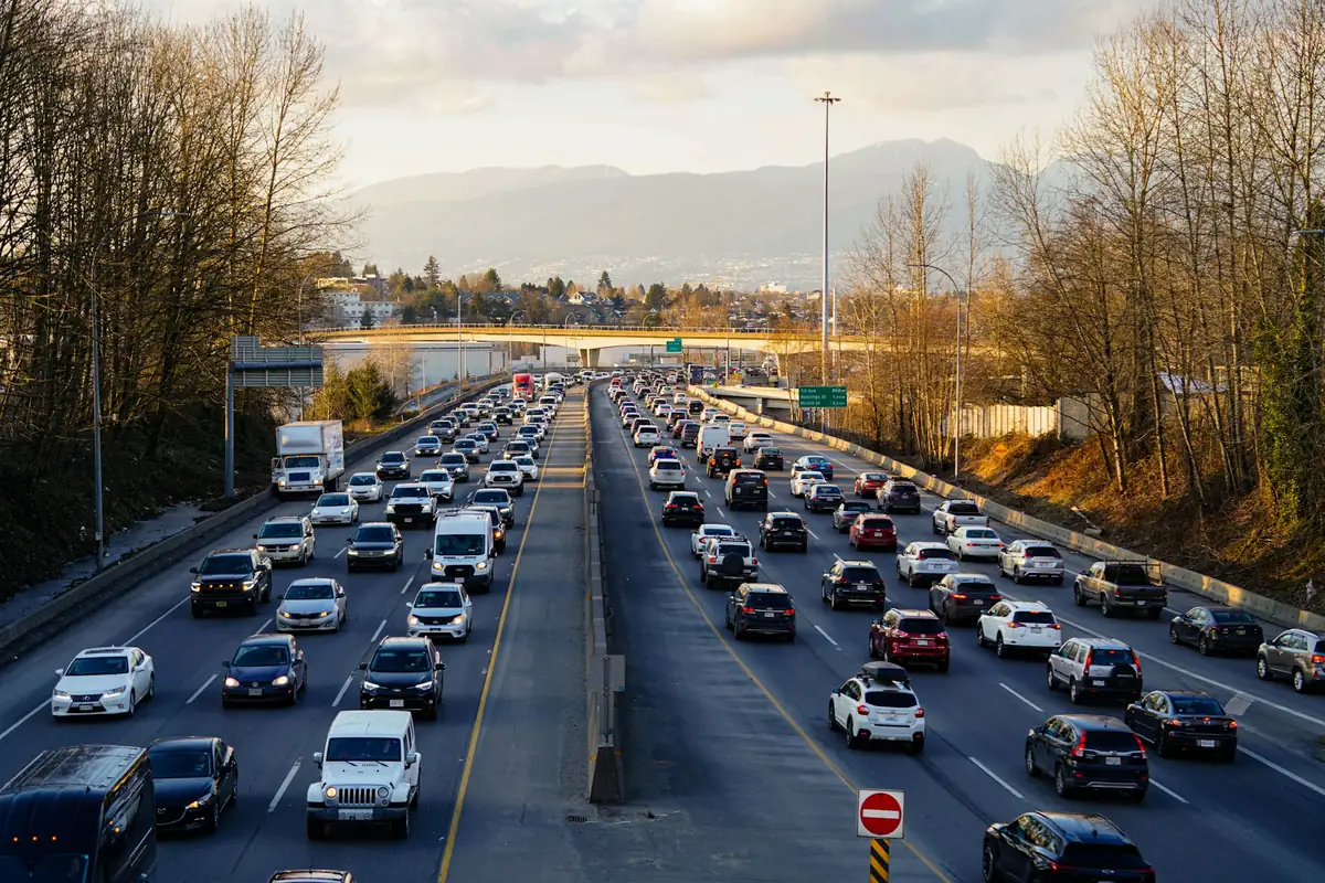 Heavy traffic on a multi-lane urban highway with trucks and cars